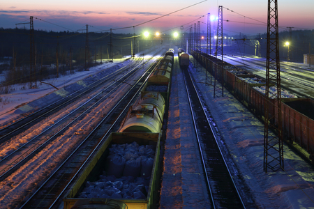Top view of freight train with carriages on railways at winter nightの写真素材