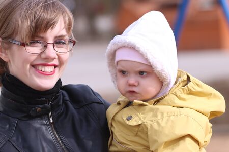 Happy mother and her little cute daughter outdoor at sunny spring dayの写真素材
