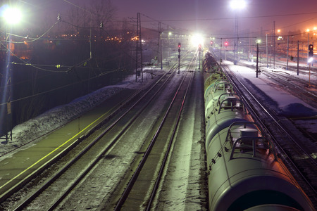 Top view of freight train with tanks on railways at winter nightの写真素材