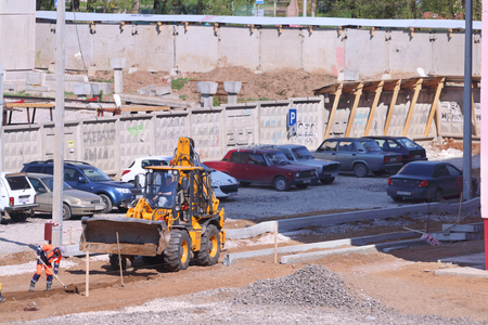 PERM, RUSSIA - MAY 15, 2015: Tractor on construction site of largest builder of Perm - Factory of silicate panelsのeditorial素材