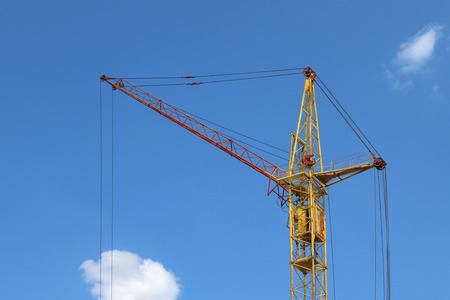 Part of stationary hoist on construction site, blue sky and white clouds の写真素材