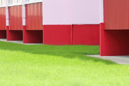 Bright green lawn grass at the house is illuminated by sunlight morning lightの写真素材