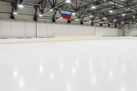 Big empty indoor new ice rick for competitions, hanging flagsの写真素材