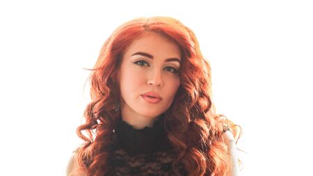 Young woman with beautiful face, curly hair and large bright eyes on white backgroundの写真素材