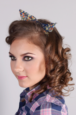 Pinup beautiful young woman in checkered shirt in studio, close-upの写真素材