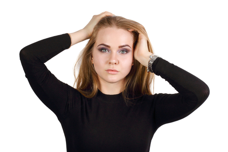 Young blonde in black clothes poses isolated on white backgroundの写真素材