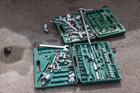 Many tools for car repairing on asphalt at sunny day outdoor
