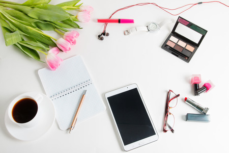 Pink tulips, tablet, cosmetics, coffee, glasses - spring female thingsの写真素材