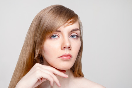 Happy young woman with make-up in studio, close up portraitの写真素材