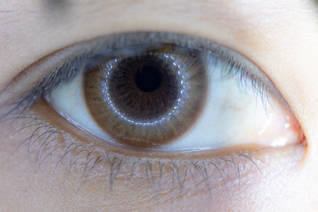 Close up of beautiful woman eye and contact lens.の写真素材