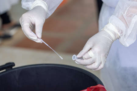 The doctor with PPE suit, Doctor is using a test coronavirus(covid-19) with the use of an ATK test...