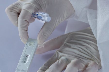 The doctor with PPE suit, Doctor is using a test coronavirus(covid-19) with the use of an ATK test...