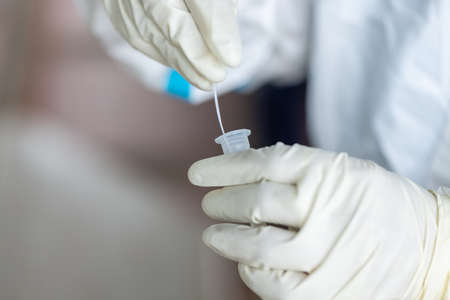 The doctor with PPE suit, Doctor is using a test coronavirus(covid-19) with the use of an ATK test...