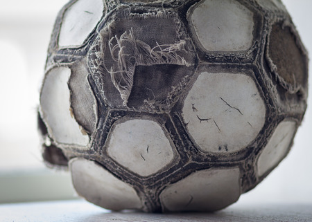 Very old cracked ramshackle ball for soccer or footballの写真素材