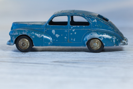 3d model of old car, heavy metal, painted in blue and shabby, on the table close-up.の写真素材