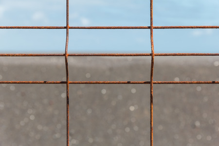 Iron fence with corrosion before horizon close-up.の写真素材
