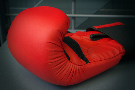 One new boxing glove on the gray background, close-up, horizontalの写真素材