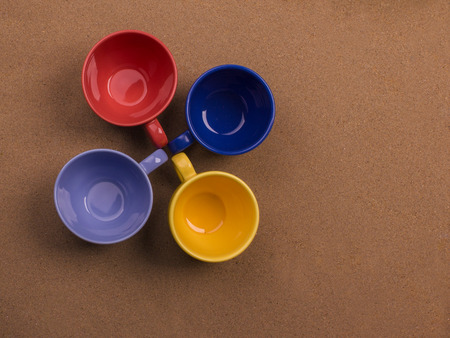 Bunch of four cups of coffee together on the sand background. Conceptの写真素材