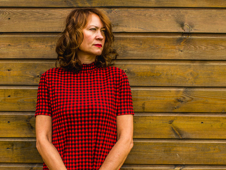 Attractive provincial woman on the wooden background of barn.の写真素材