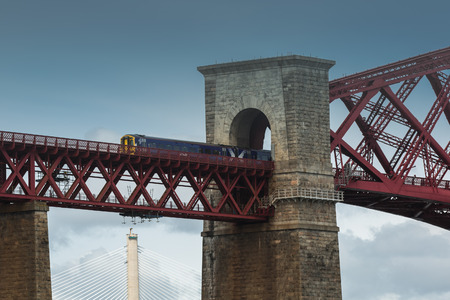 Fragment of Railway with train over The Firth of Forth Edinburgh Bridge, crossing between Fife and...