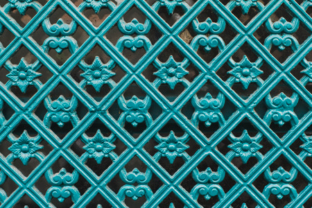The door with decorative metal pattern turquoise colored element. Colorful image, detail.の写真素材