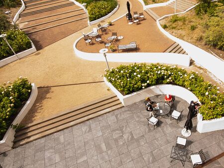 Top view of the luxurious outdoor furniture on the hotel terrace in the cafe. Sidewalk with tables...