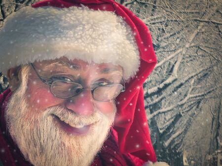 close-up view of santa claus in eyeglasses holding bag and looking at camera