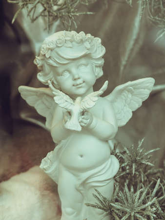 Statue of Christmas little Angel, close up, toned image.の写真素材