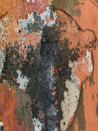 Grungy concrete wall background texture with damaged layers of stucco and pink paint, frontal photo,...
