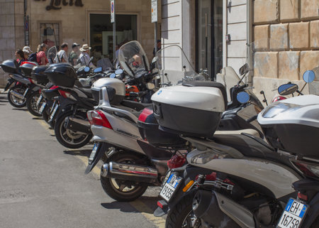 LECCE, ITALY APRIL 4, 2018 Parking of light two-wheeled motorcycle, city transport.のeditorial素材