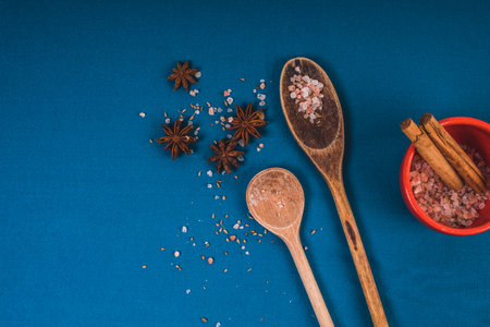 Group of kitchen tools with spices on blue background, top view and copy space for design foods, spices, healthy lifestyle or other your content.の写真素材
