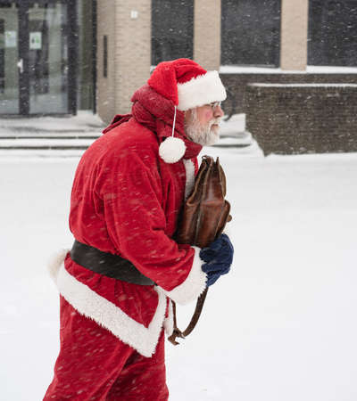 Santa Claus goes to work in snowy and cold weather. New job concept.の写真素材