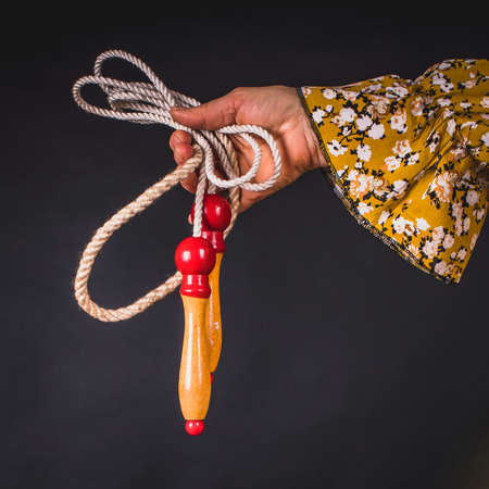 Close-up of a skipping rope in a woman's hand. Jump rope is a tool used in the sport of skipping or jump rope.の写真素材