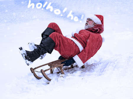 Santa Claus rushes in his sleigh from the mountain and shouts ho ho ho!の写真素材