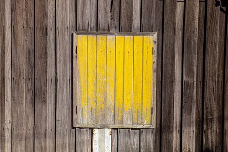 Old style window painted yellow.の写真素材
