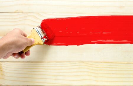 paint brush red color on wood background