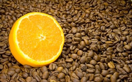 half orange slice of coffee beansの写真素材