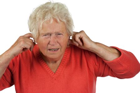 senior woman shut her ears on white backgroundの写真素材