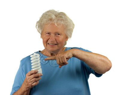 senior woman is pointing to a energy efficient lightの写真素材