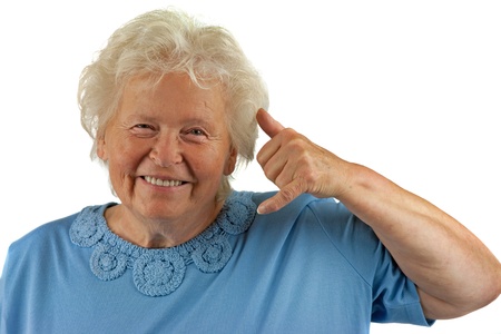 senior woman is making a call me gesture