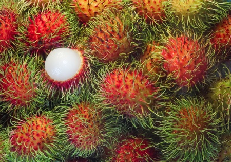 tropical fruit ,close up rambutan and one peeled from Thailandの写真素材