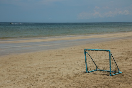 blue football goal on the beach and blue skyの写真素材