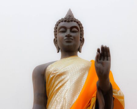 isolated white background of buddha statue in golden robe at Watyai Intaran in Chonburi province, Thailandの写真素材