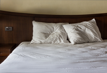 two white  wrinkle pillow on bedの写真素材