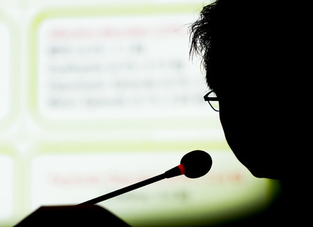 silhouette speaker on presentation with slideの写真素材