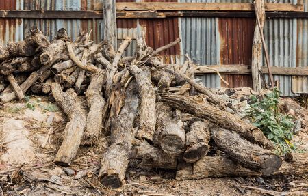 pile of old wooden pole and galvanized iron fenceの写真素材