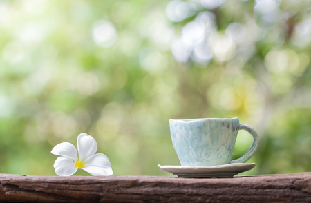 coffee cup and white  flower on tableの写真素材