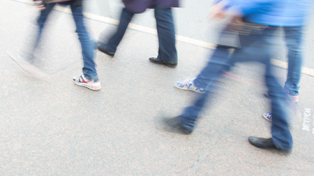 people leg walking on sidewalk in blur