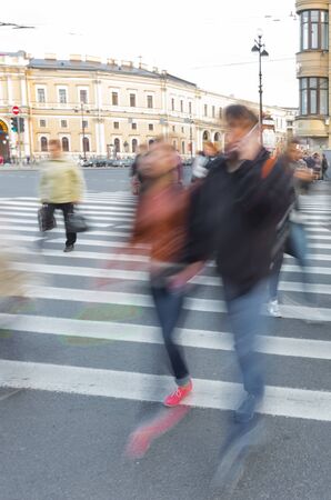 lovers walking on crosswalk in blurの写真素材