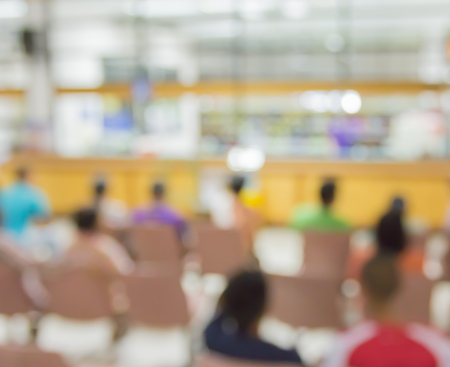 Blurred people and patient waiting doctor or medicine in hospitalの写真素材